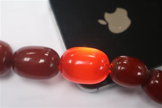 A single strand graduated simulated cherry amber necklace and a similar bracelet.